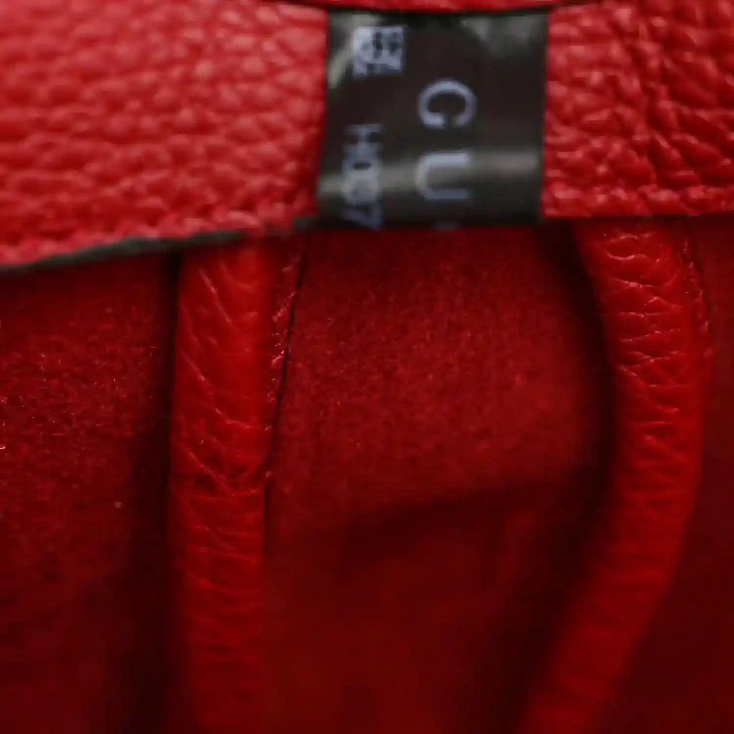 Gucci small red calfskin hobo bag, close-up of leather and top edge hardware