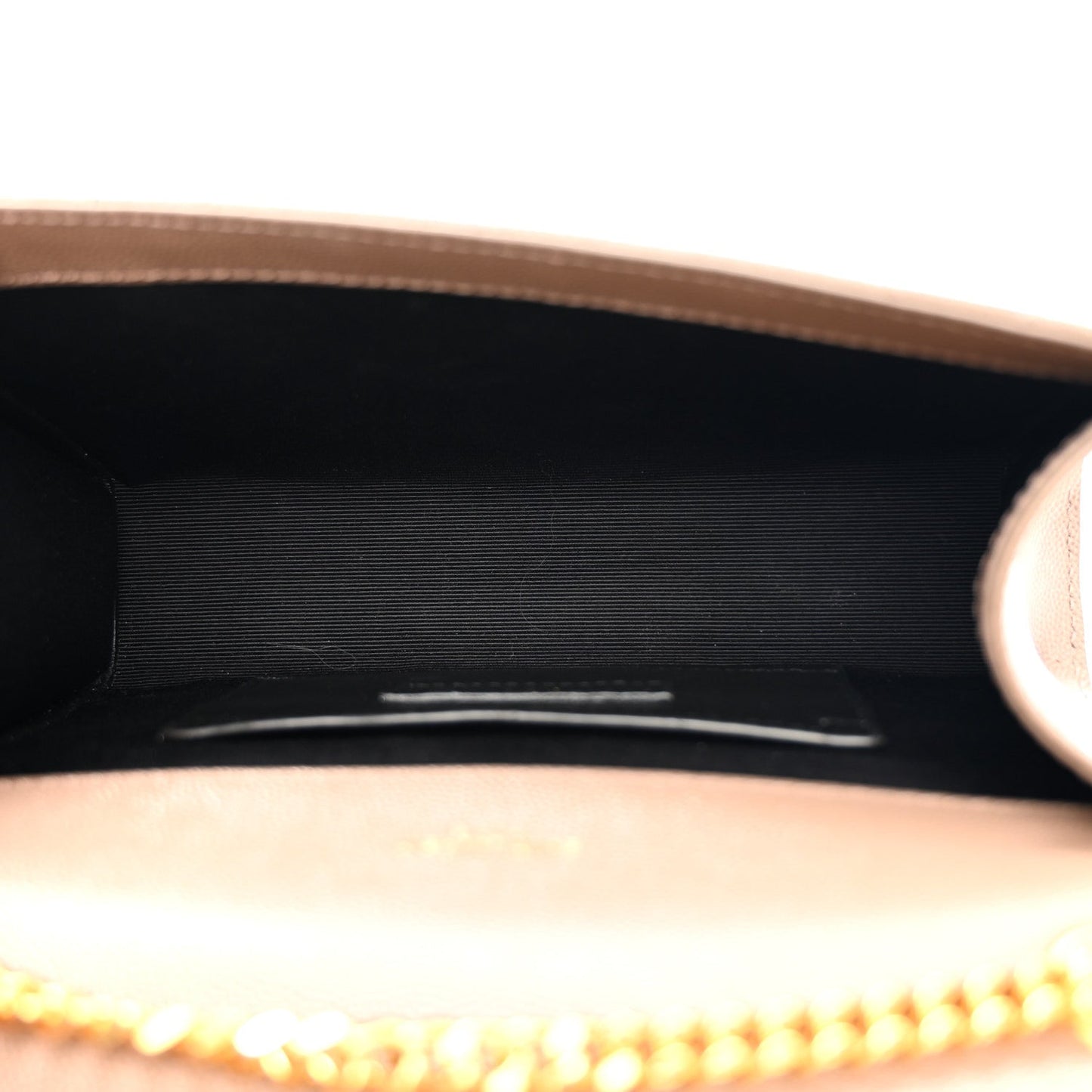 Dark beige satchel interior with black lining and gold chain edge