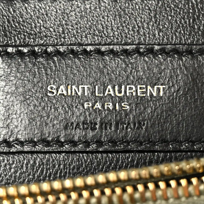Black leather label on bag interior with “SAINT LAURENT PARIS” text and stitching