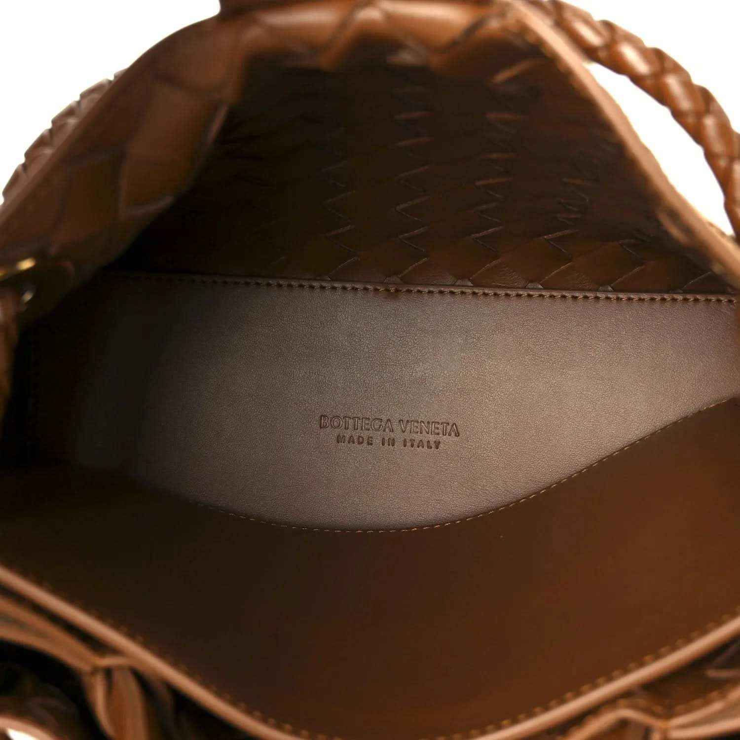 Amber suede interior of shoulder bag with printed brand logo