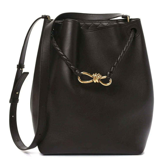 Small bucket bag in dark leather with gold-tone clasp and braided trim
