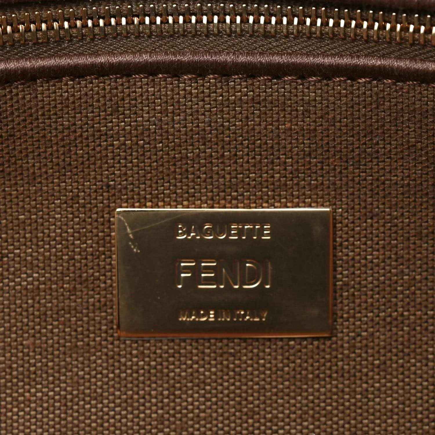 Gold-tone Fendi Baguette logo plaque on a brown interior fabric lining