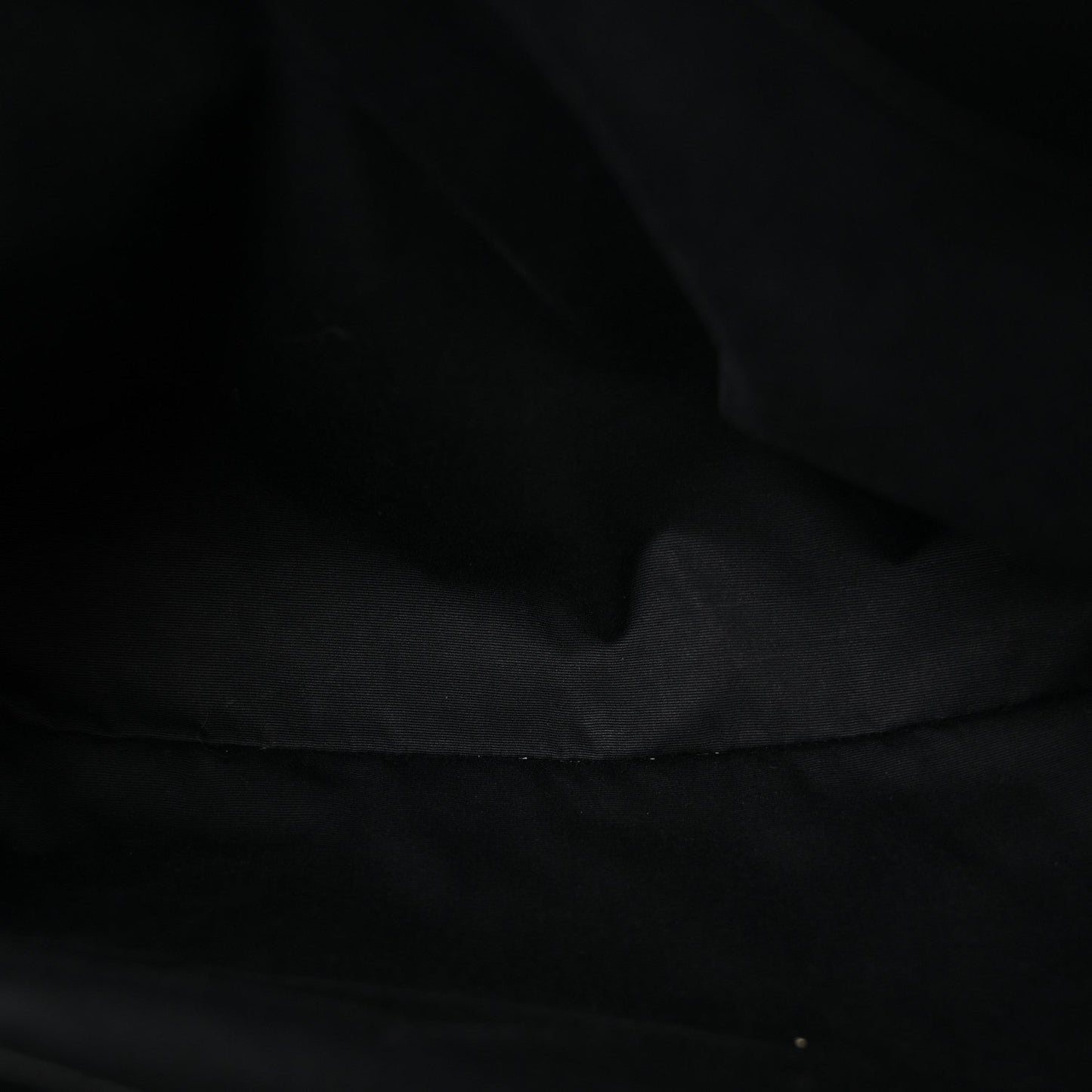 Black fabric lining inside the quilted satchel