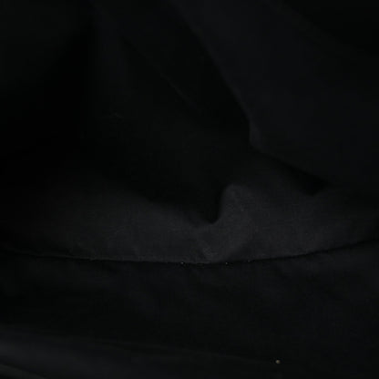 Black fabric lining inside the quilted satchel