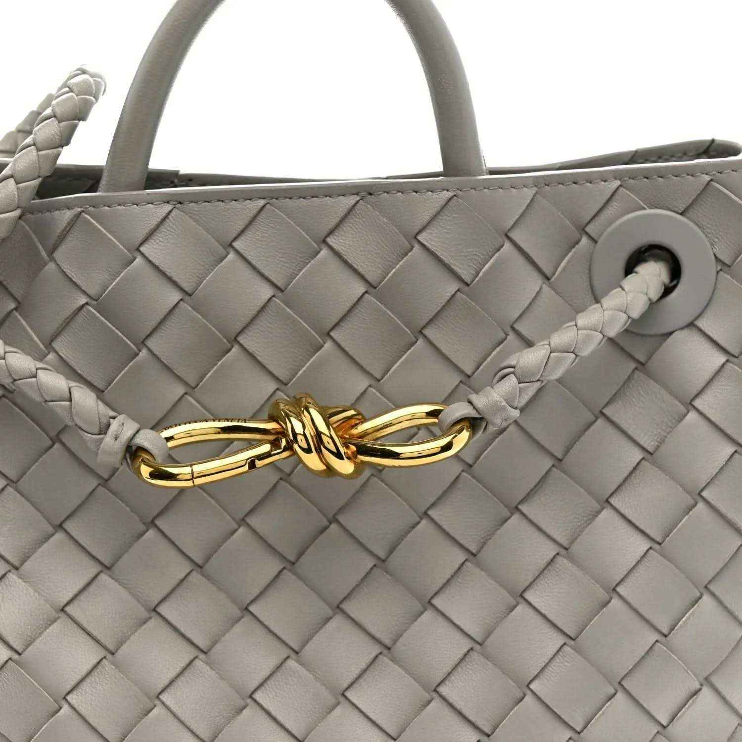 Andiamo shoulder bag front in sterling grey woven nappa with gold clasp and braided pull