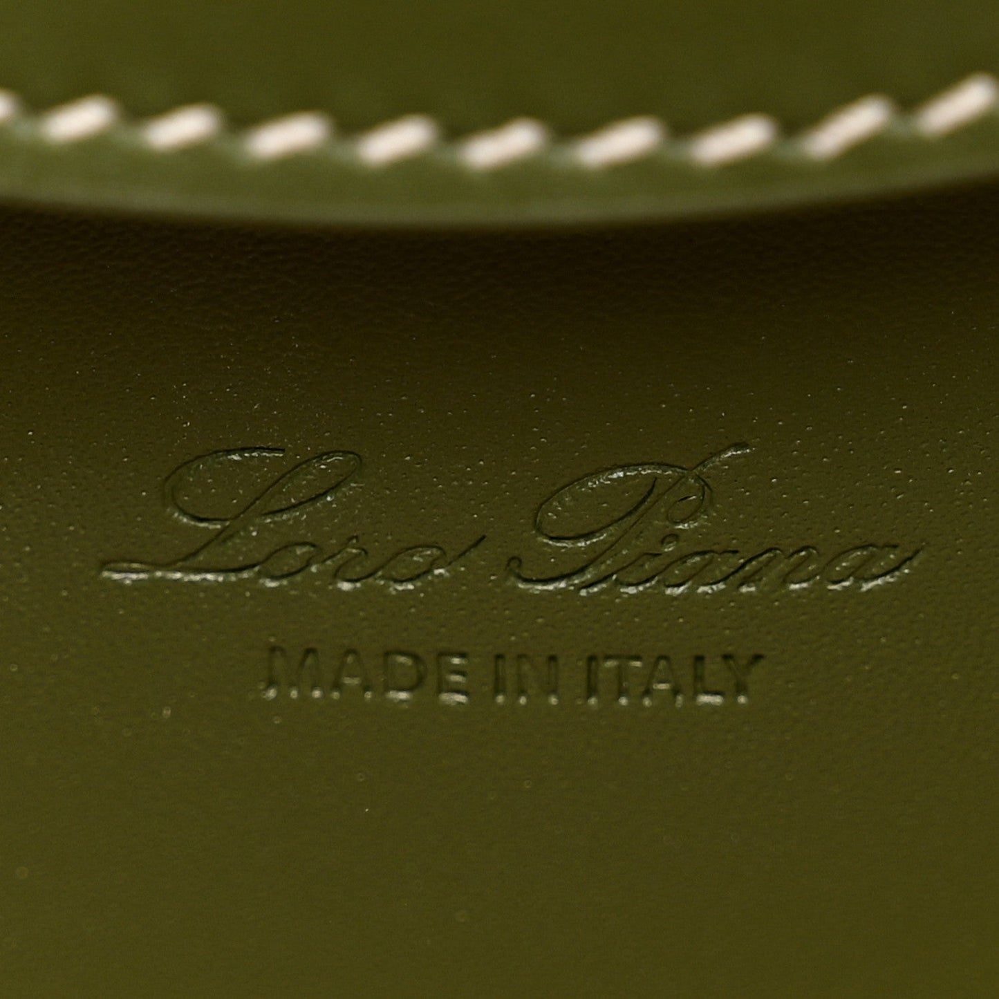 Olive green leather interior panel with embossed Loro Piana logo and MADE IN ITALY