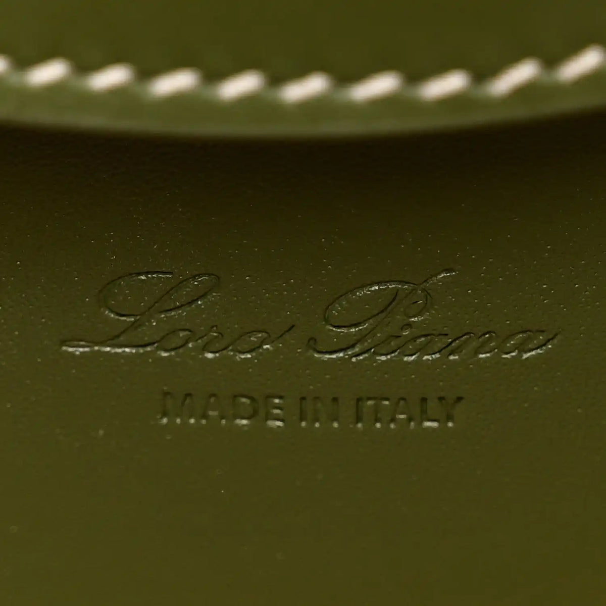Olive green leather interior panel with embossed Loro Piana logo and MADE IN ITALY