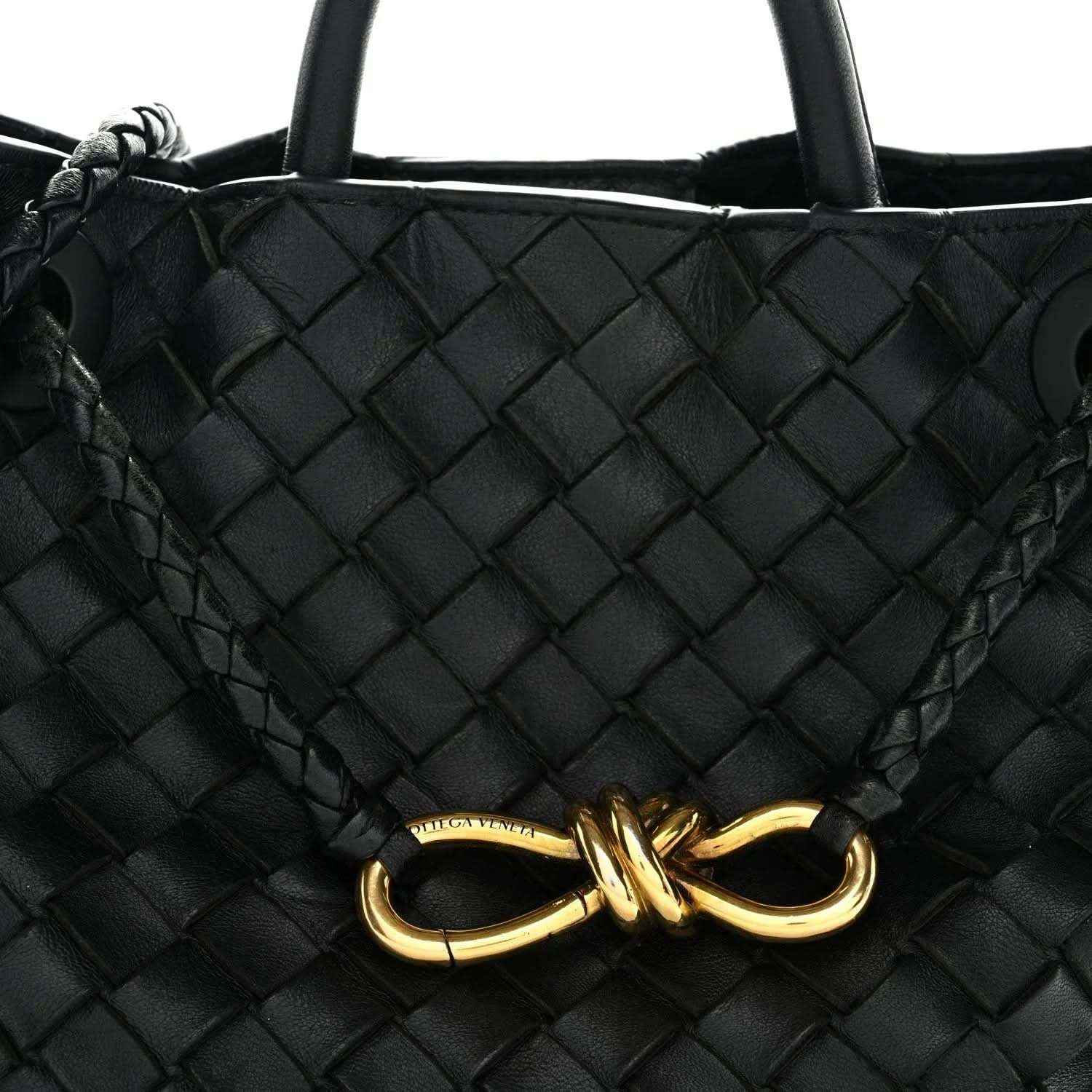 Black woven leather shoulder bag with gold clasp front detail