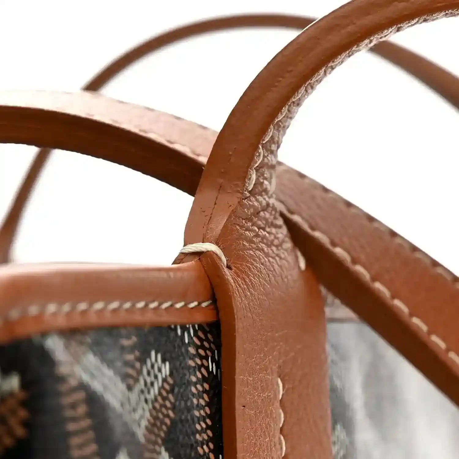 Black Goyardine canvas tote bag with leather handles and white stitching detail