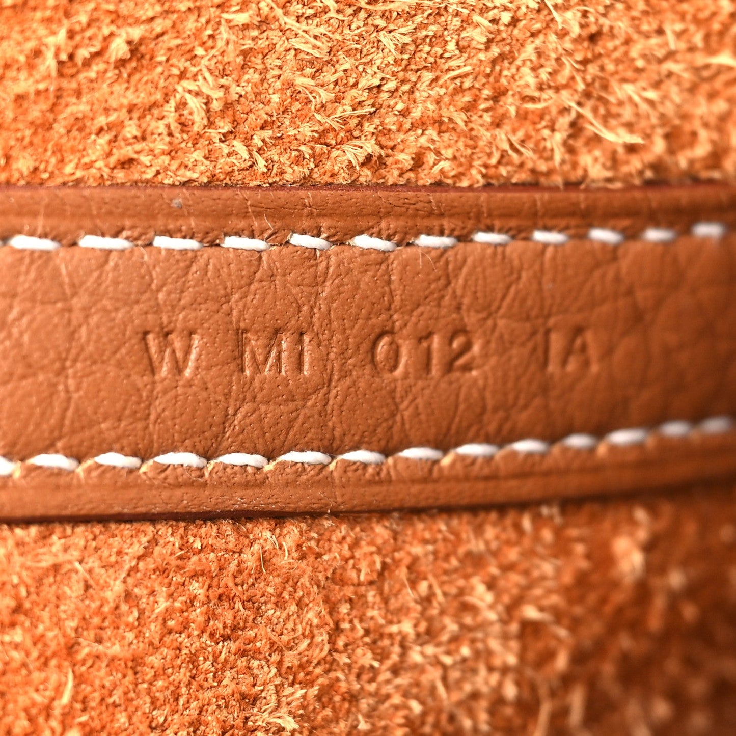 Leather date code WM 012 TA with white edge stitching, tan/brown.