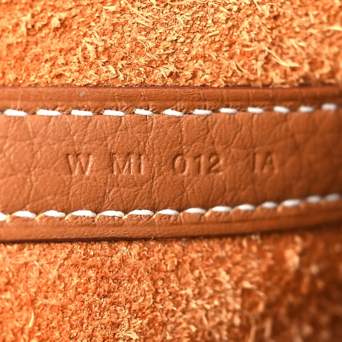 Leather date code WM 012 TA with white edge stitching, tan/brown.