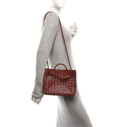Small woven leather tote bag in Sapele brown, worn crossbody with short straps
