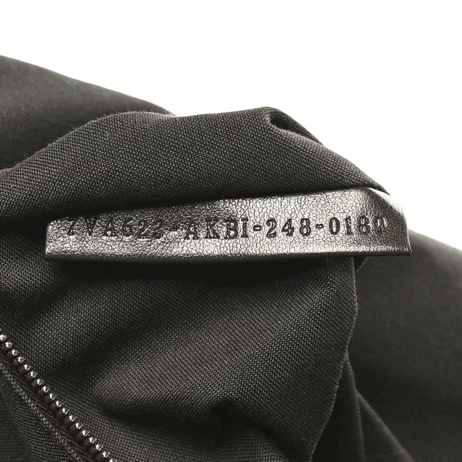 Fendi Baguette fabric size tag on dark lining, '4M8-248-018' text visible.