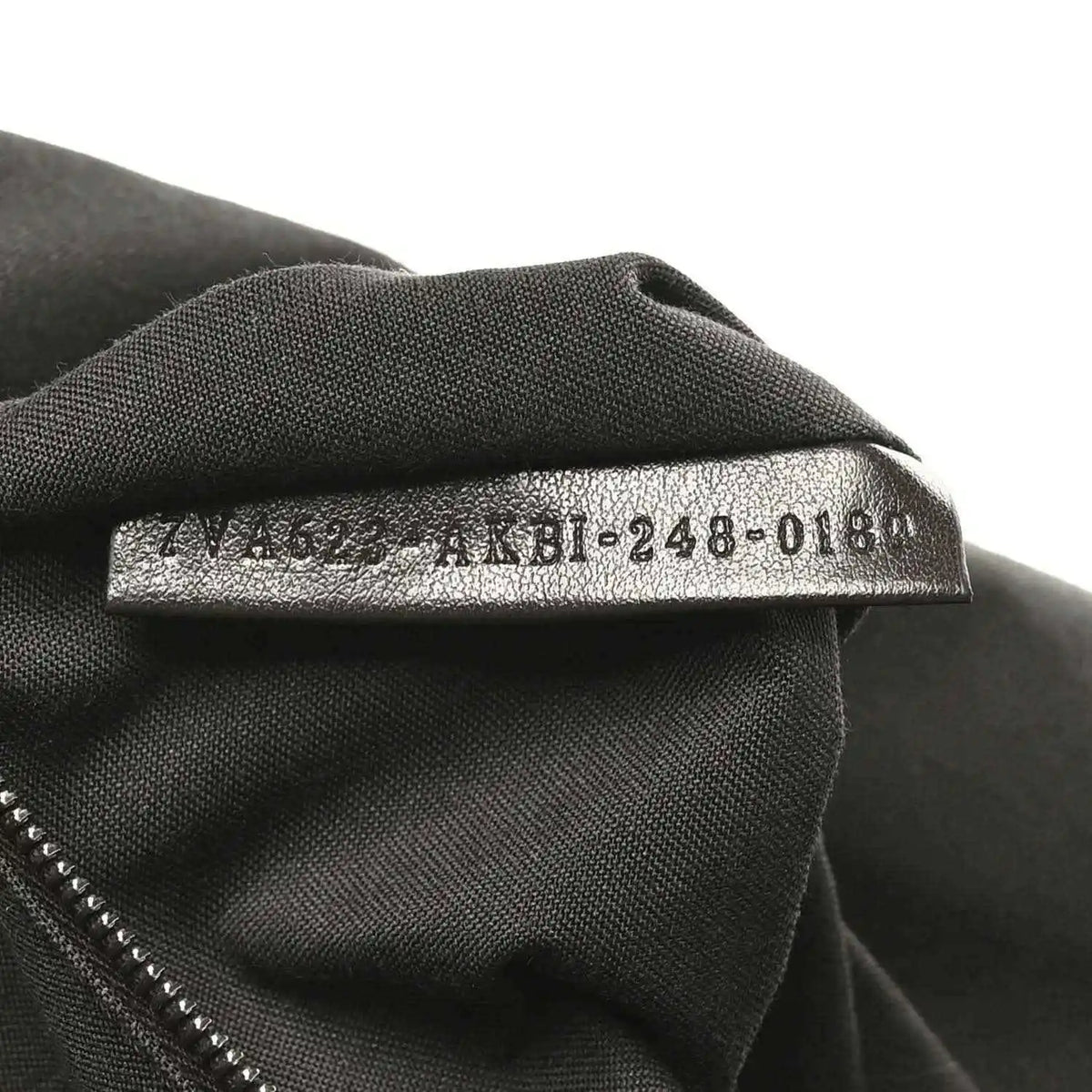 Fendi Baguette fabric size tag on dark lining, '4M8-248-018' text visible.