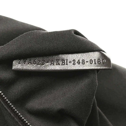 Fendi Baguette fabric size tag on dark lining, '4M8-248-018' text visible.