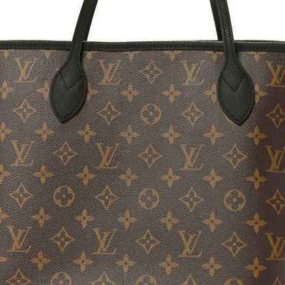 Monogram canvas close-up with black leather handles and stitching
