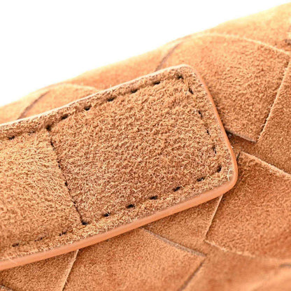 Amber suede corner close-up with stitched edge and textured material detail