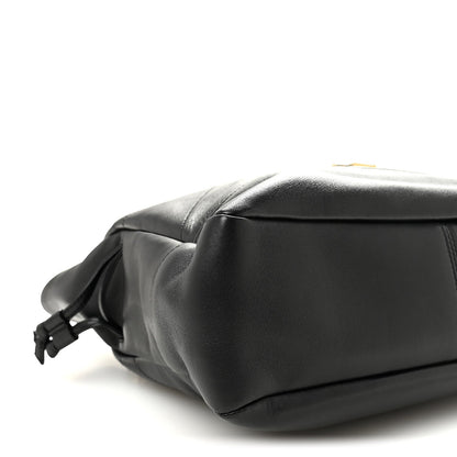 Black lambskin tote end view with braided drawstring bow and smooth leather base.