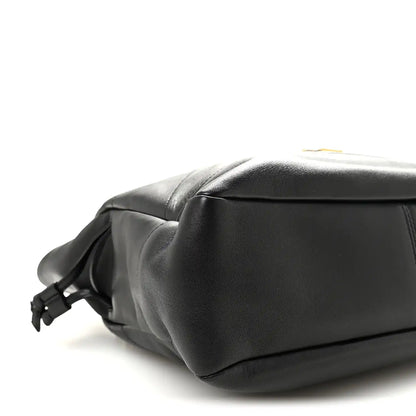 Black lambskin tote end view with braided drawstring bow and smooth leather base.