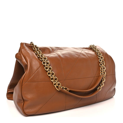 Tan-brown leather shoulder bag with quilted panels and gold chain strap.