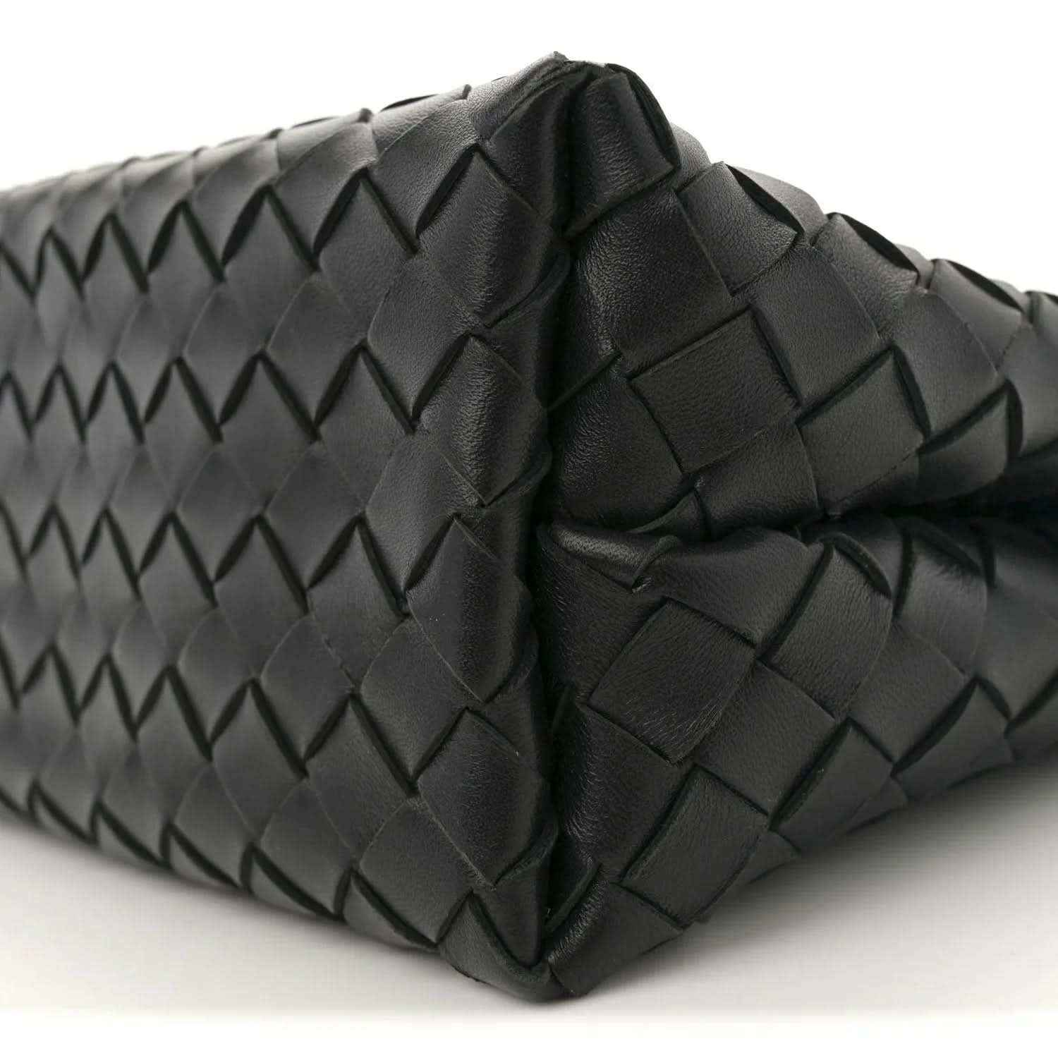 Black leather shoulder bag side with intrecciato weave and stitched folded panels