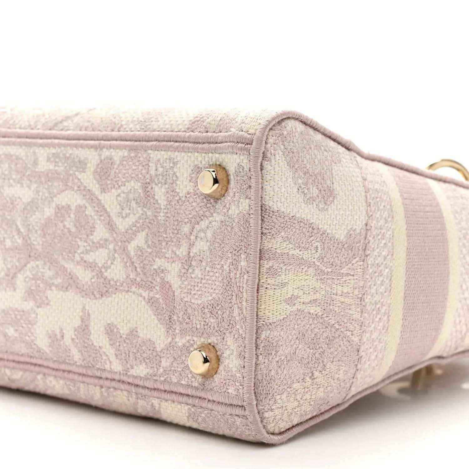 Rose-pink embroidered handbag end panel with two gold studs and raised trim edging