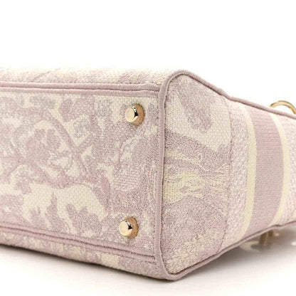 Rose-pink embroidered handbag end panel with two gold studs and raised trim edging