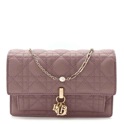 Purple quilted leather chain pouch bag with flap closure and gold-tone emblem hardware