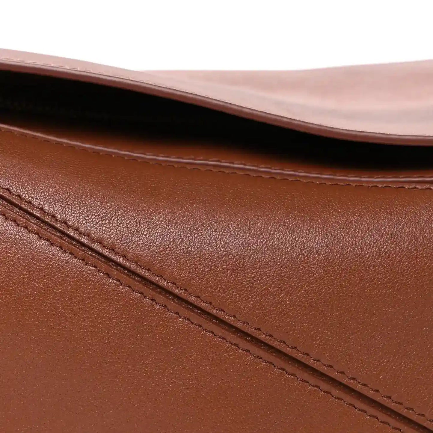 Pecan brown leather bag close-up of top edge and diagonal stitched panel seam