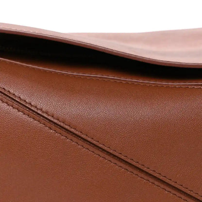 Pecan brown leather bag close-up of top edge and diagonal stitched panel seam