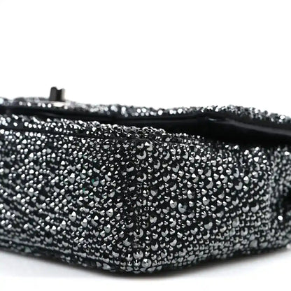 Black rhinestone small flap bag bottom edge with hinge post and curved profile