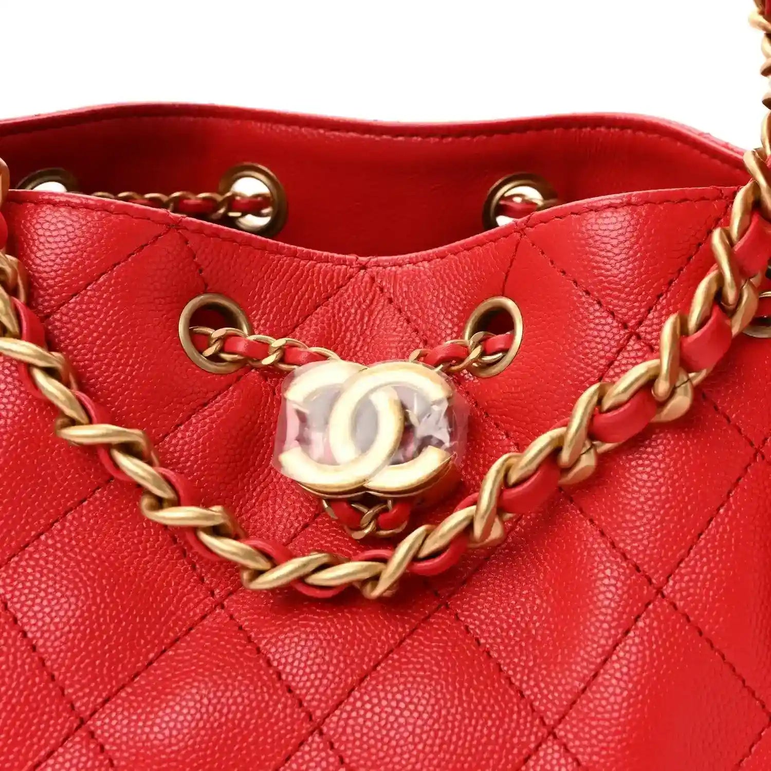 CC clasp with gold chain on quilted burgundy leather handbag front.