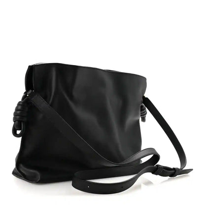 Black Nappa calfskin clutch bag with knot detail and long crossbody strap