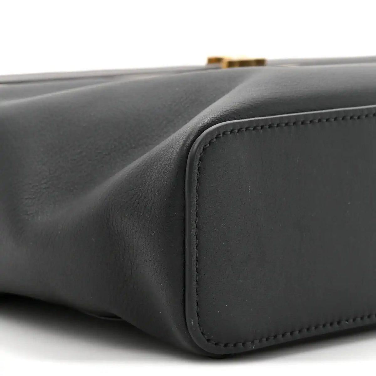 Black leather rectangle bag side corner with rounded panel and edge stitching