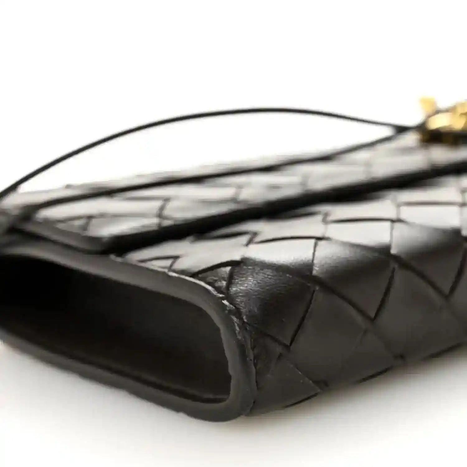 Black intrecciato clutch corner with curved leather edge and top handle
