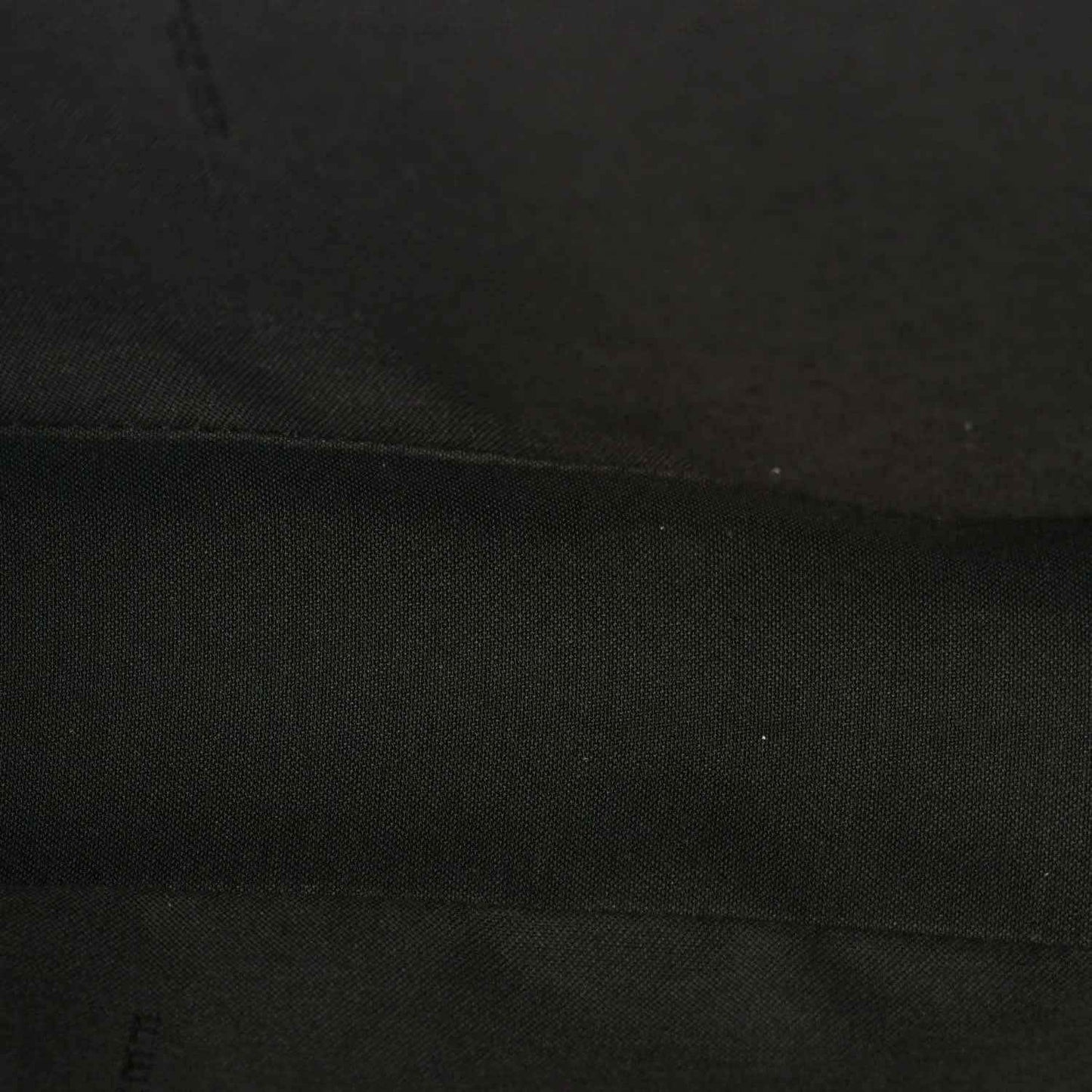 Fendi baguette bag lining close-up in dark fabric with subtle texture