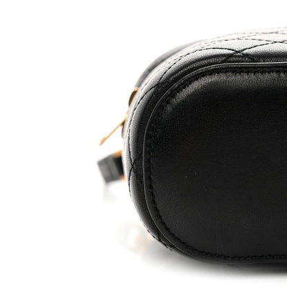 Black lambskin quilted mini vanity case with rounded edge and contrast stitching