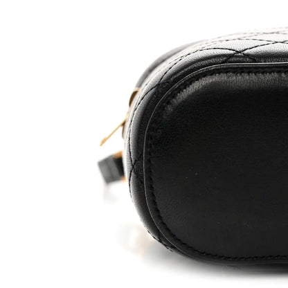 Black lambskin quilted mini vanity case with rounded edge and contrast stitching
