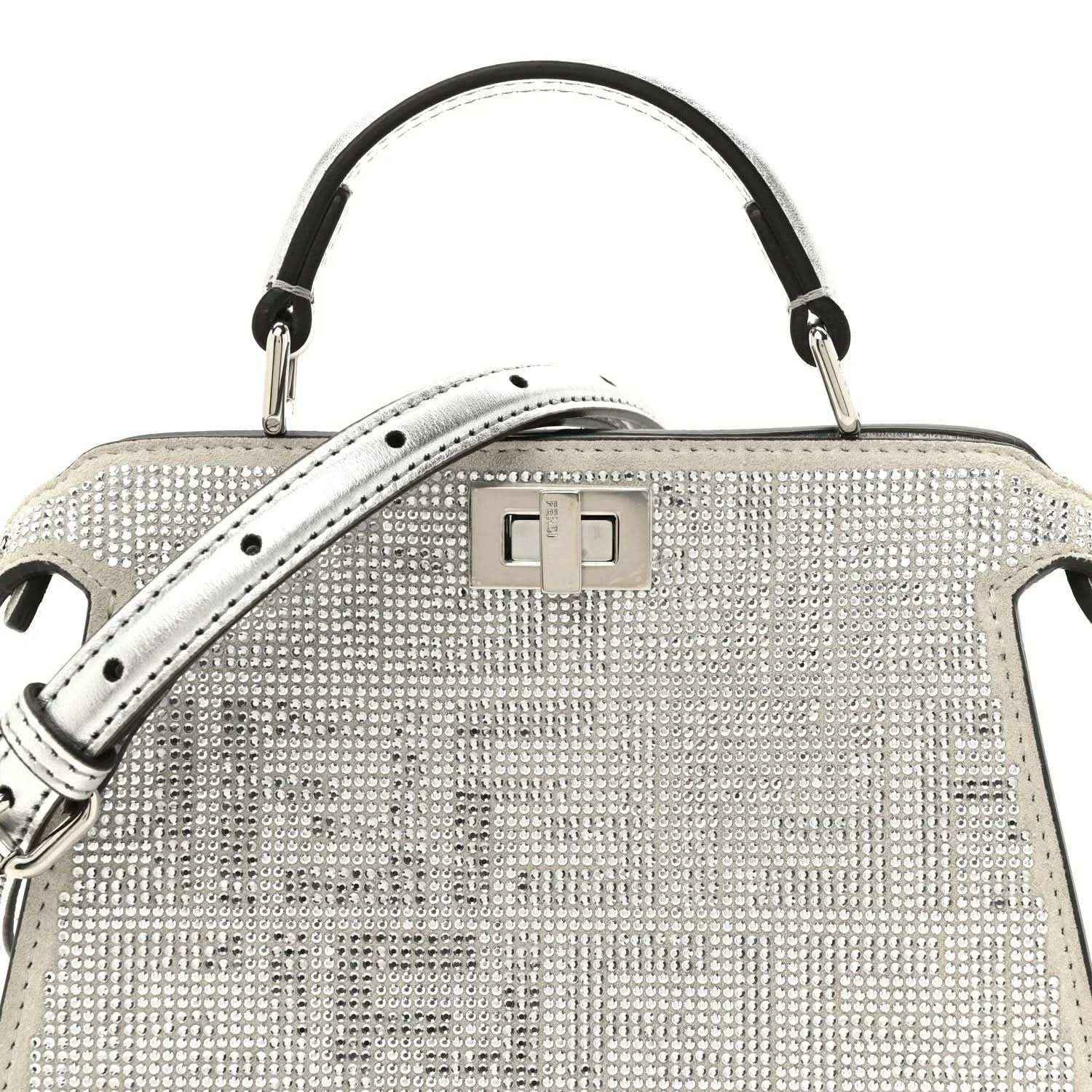 Silver crystal satchel front with top handle, flap clasp, and studded texture