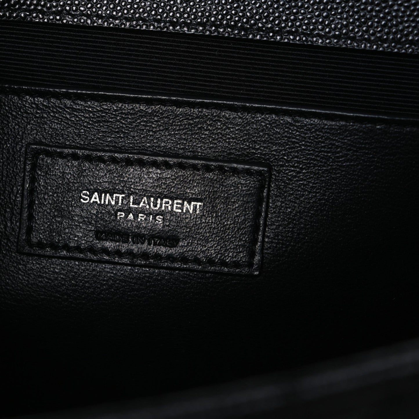 Black leather satchel interior label patch reading SAINT LAURENT PARIS