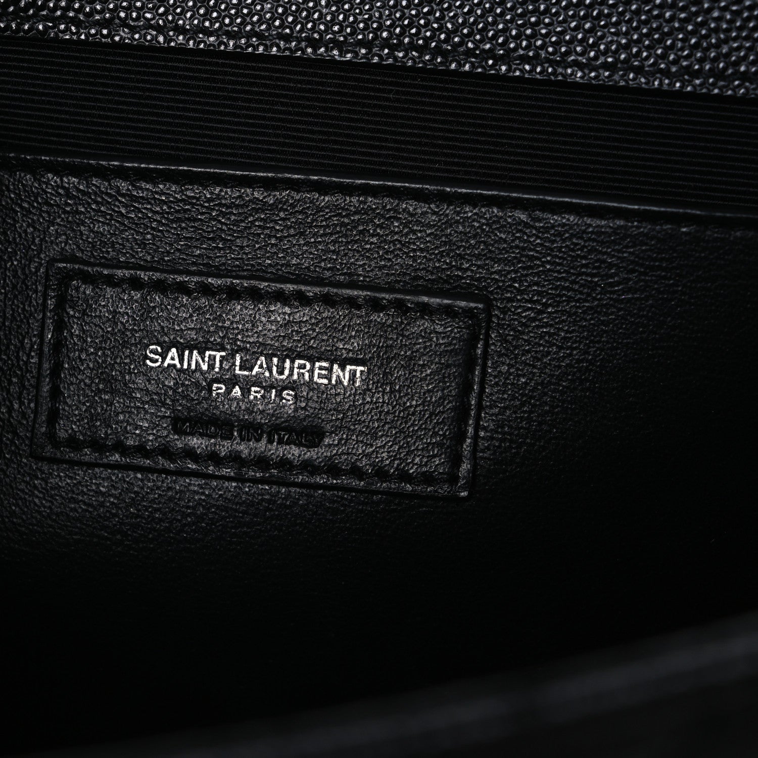 Black leather satchel interior label patch reading SAINT LAURENT PARIS
