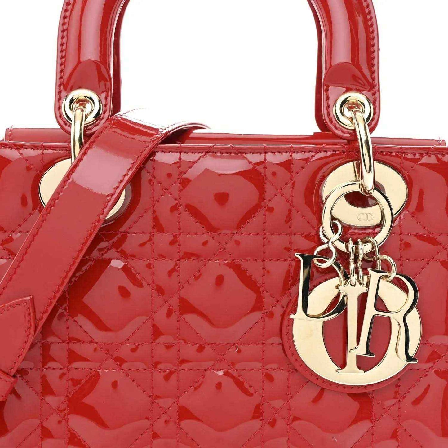 Christian Dior small red patent quilted handbag, close-up of top handles and Dior charm
