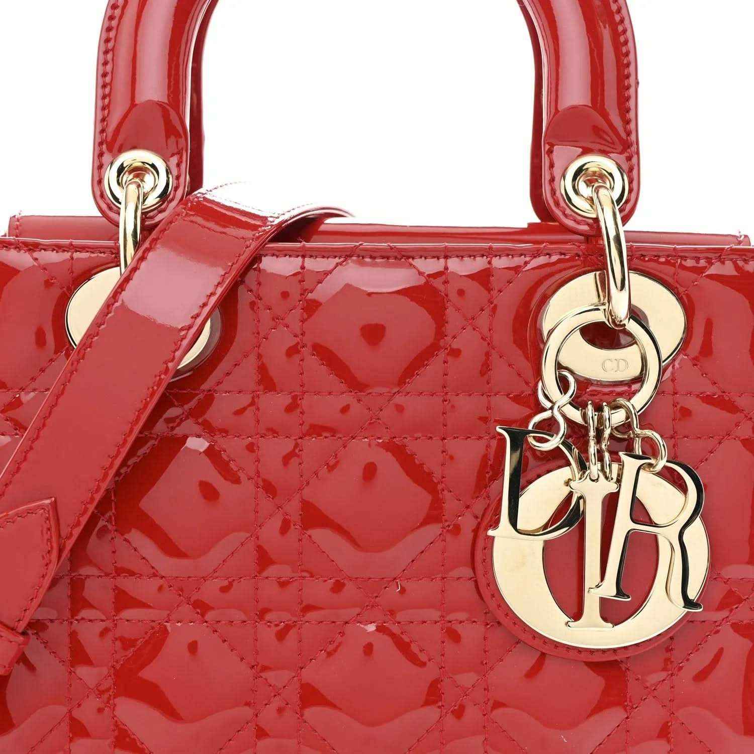 Christian Dior small red patent quilted handbag, close-up of top handles and Dior charm