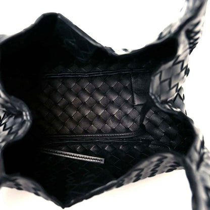 Black intrecciato leather bag interior with stitched seams and zipper trim