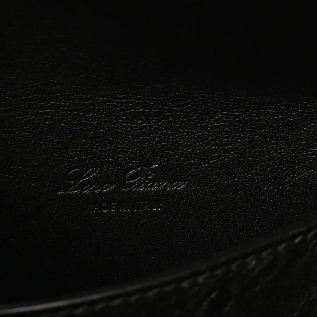 Black ostrich leather with embossed Loro Piana logo on inner base.