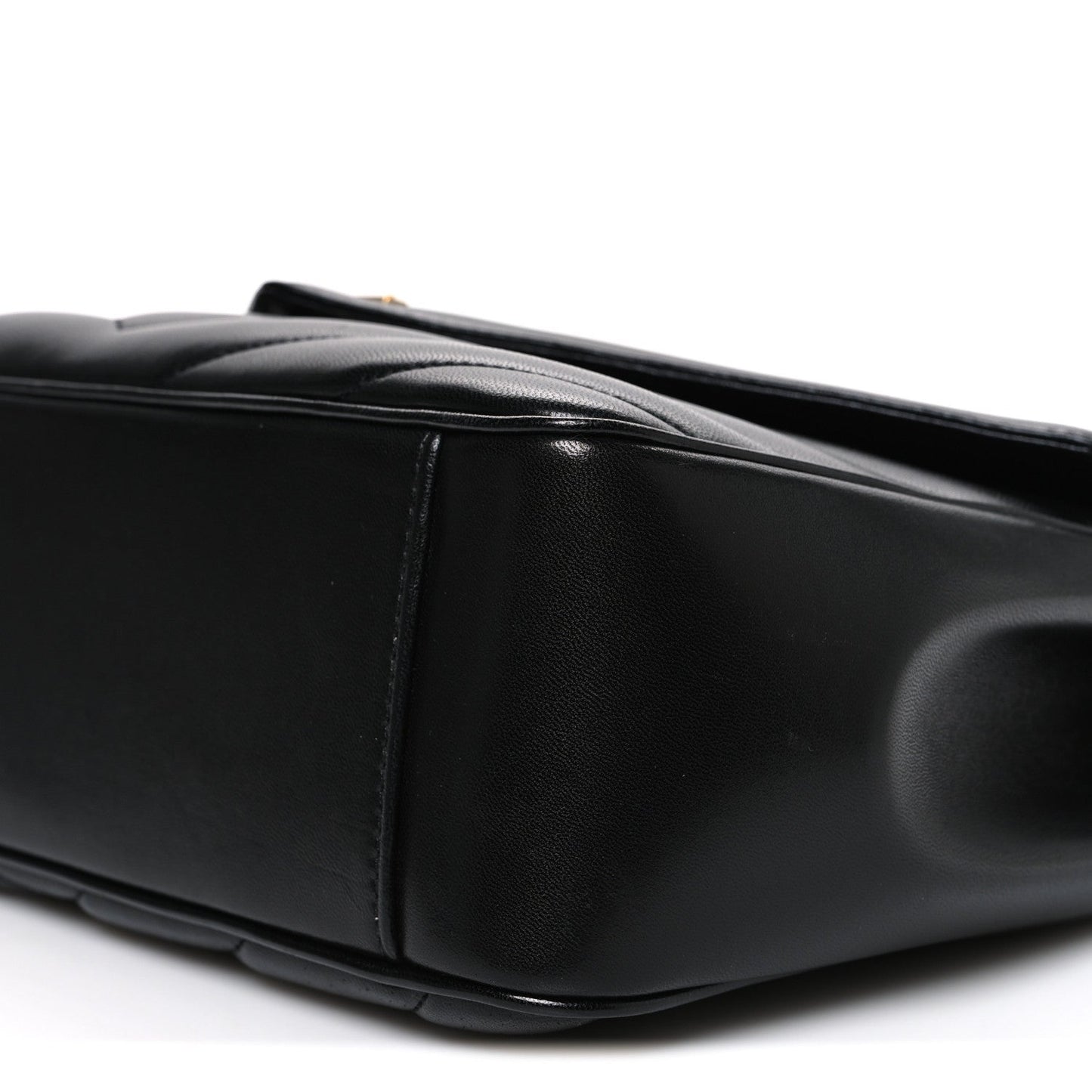 Black quilted leather shoulder bag, side view with top handle and stitching