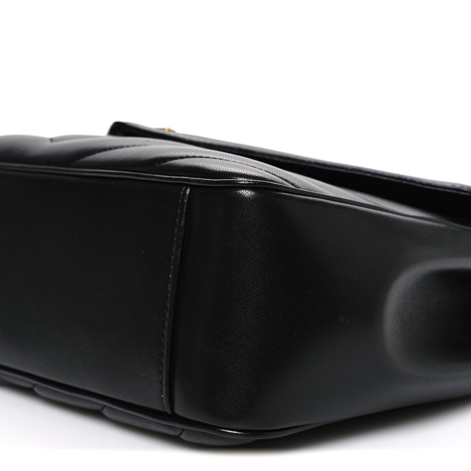 Black quilted leather shoulder bag, side view with top handle and stitching