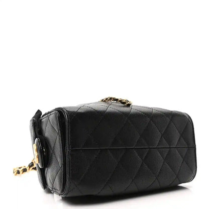 Black leather quilted mini handbag with gold chain shoulder strap and flap detail