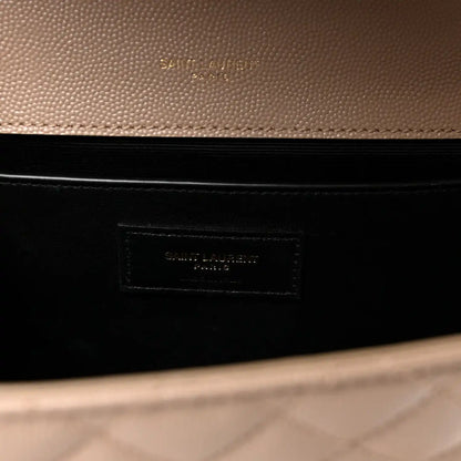 Dark lining interior of satchel with embossed brand patch label in a beige outer frame.