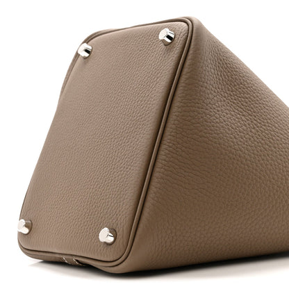 Etoupe leather bag corner with three metal feet and stitched edge